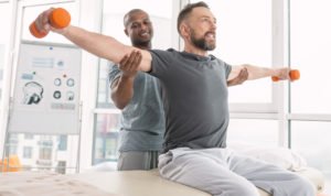 Man lifting weights during physical therapy session