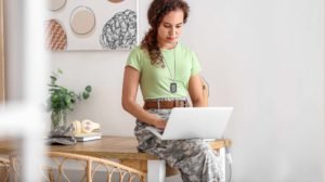 Young female veteran researching veterans benefits